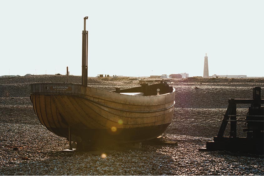 fishing boats on a pebble beach