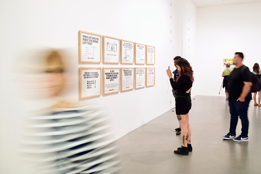 interior of an art gallery with people viewing art